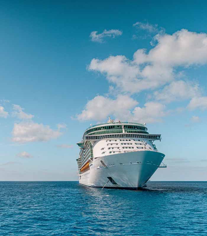 Luxury world cruise ship sailing at sunset - Premium cruise vacation packages